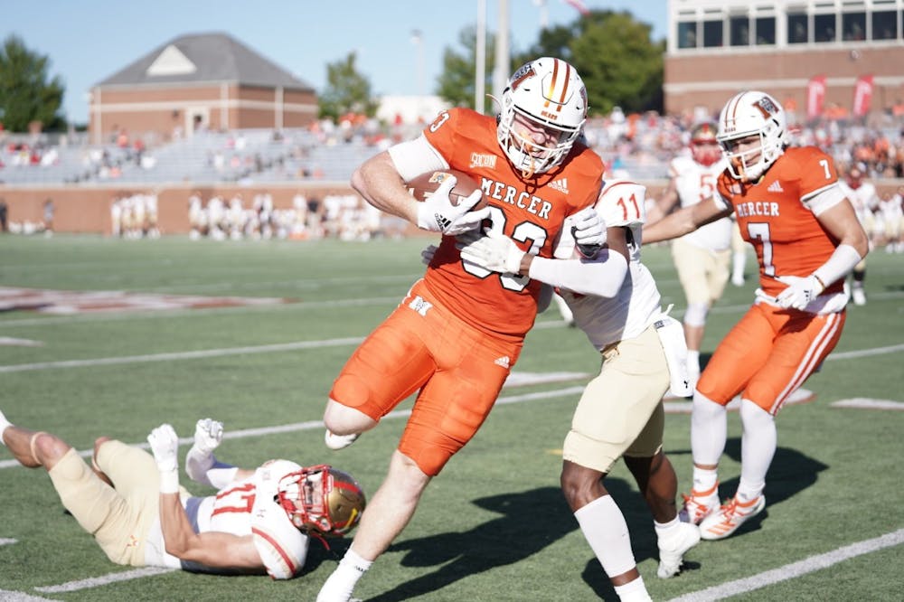 <p>Mercer tight end Drake Starks barrels through defenders during Saturday&#x27;s game against VMI. The Bears would lose the game 45-7. Photo provided by Mercer Athletics.</p>
