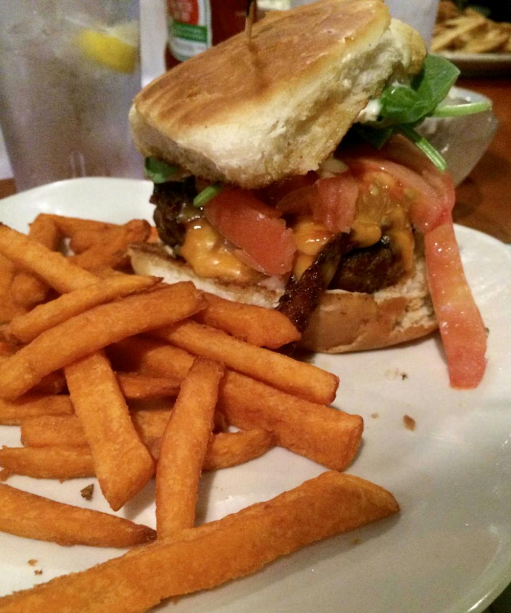 The Players Club Brisket Burger: ground brisket, jalapeno bacon, smoked cheddar, spinach, tomato, and horseradish sauce. Interesting flavors and textures. Served with crispy sweet potato fries.