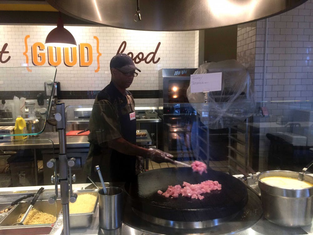 Carl McCoy prepares a fresh meal in the Farmer's Market.