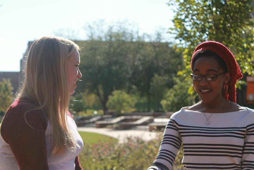 Summer Perritt Interviewing international student Mhpo Molapo by Cruz Plaza.