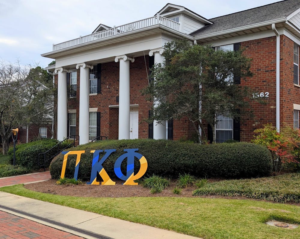 Pi Kappa Phi's house sits with the fraternity's three letters displayed outside.