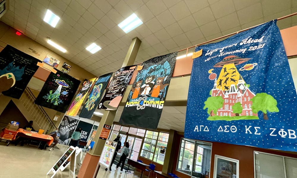 <p>A handful of the winners from the Homecoming banner contest hang in the Connell Student Center, including the first-place winner from the large bracket — Alpha Gamma Delta, Delta Sigma Theta, Kappa Sigma and Zeta Phi Beta — visible on the right. </p>
