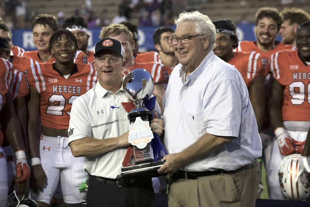 <p>Drew Cronic lifts the FCS Kickoff trophy following Mercer&#x27;s win over the University of North Alabama. Cronic leaves Mercer with a 28-17 overall record and a handful of program records. He is now moving on to be offensive coordinator for the Navy Midshipmen.</p>
