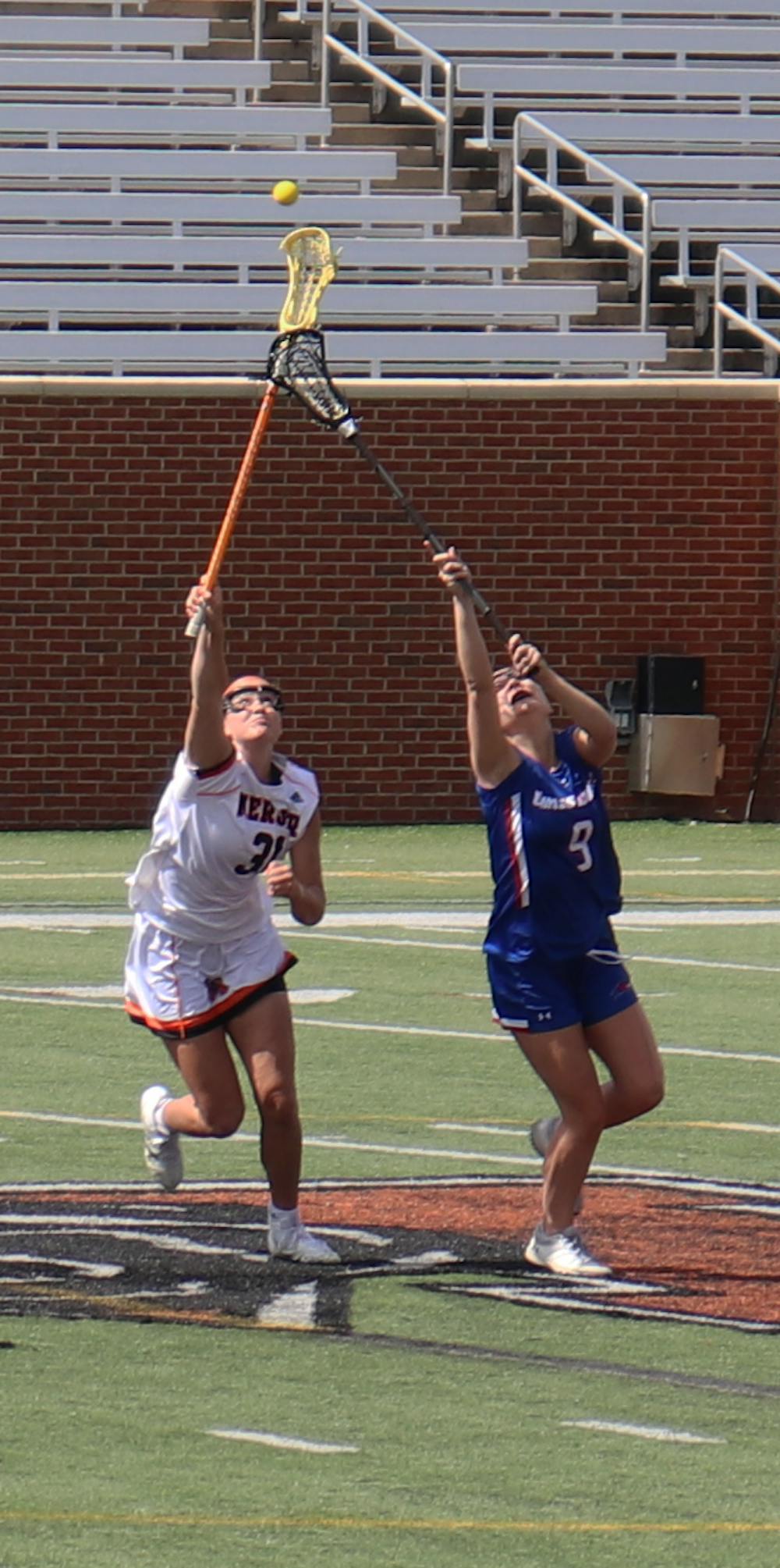<p>Mercer player Erin Degnan (#31) fighting for the ball in their game against the UMASS Lowell on March 6. (Photo by Noah Grant)</p>