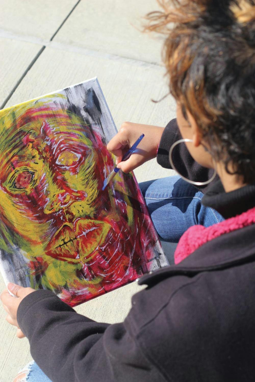 A student works on a painting.