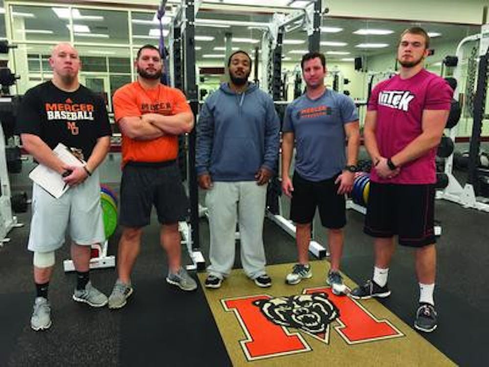 Rod Hill (center) is heading back to his alma mater, Howard University, as the director of strength and conditioning after spending over a year as a graduate assistant at Mercer.