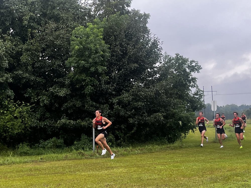A pack of Mercer cross country runners race in the rain on Saturday at the MGA/Julius Johnson Invitational.