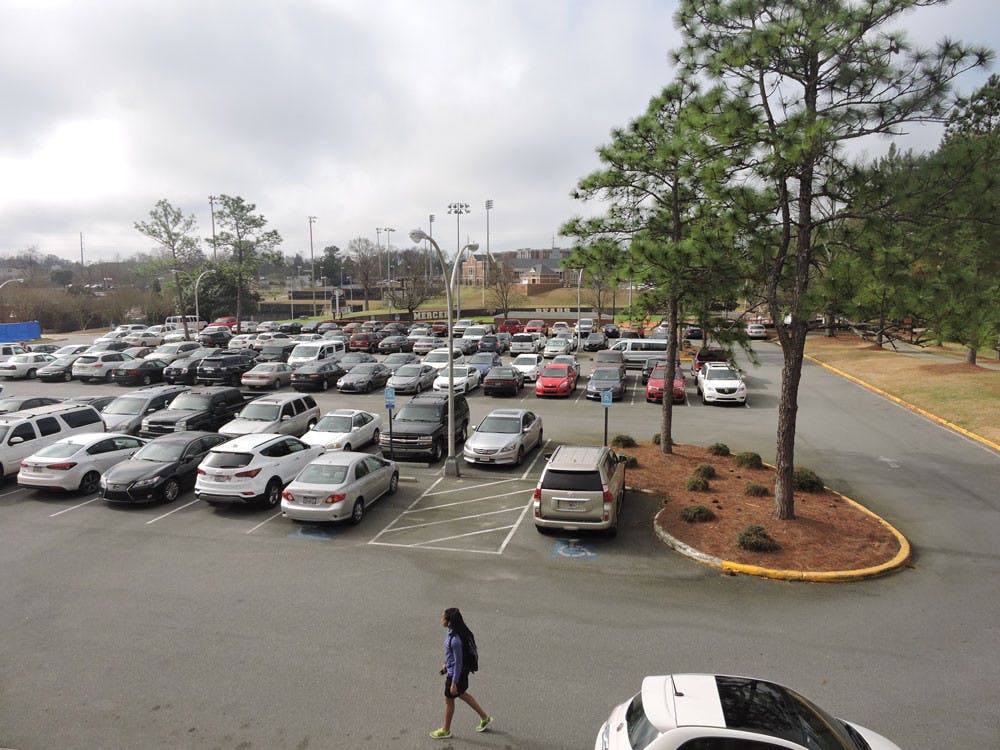 Student passes through the parking lot behind Stetson to get to class. 