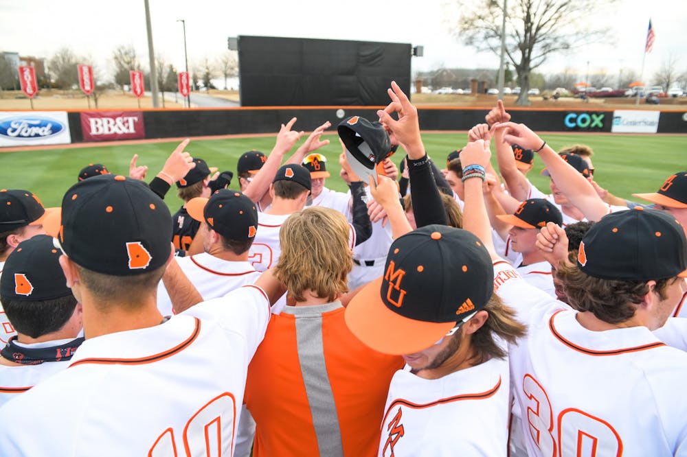 Mercer baseball players huddled together before their game against FAMU in March of 2021.  