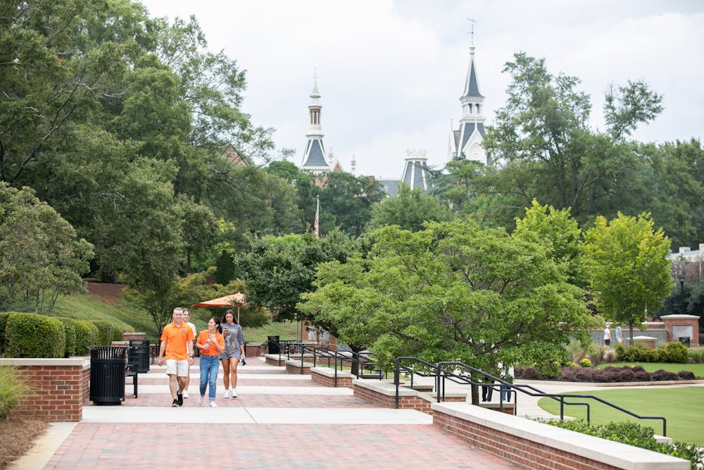 <p>Students walk down Cruz Plaza with the spires of Mercer&#x27;s historic quad buildings in the background. (Christopher Ian Smith/Mercer Office of Marketing Communications)</p>