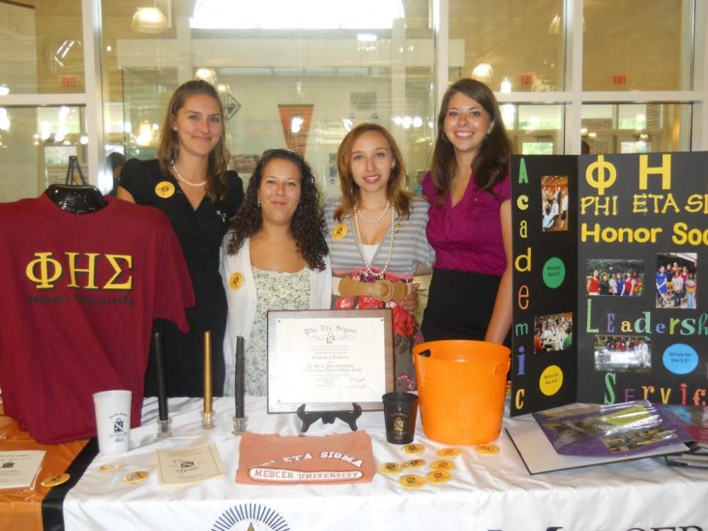 Members of Phi Eta Sigma present information about the national honor society to freshmen at this year’s Bear Fair. 