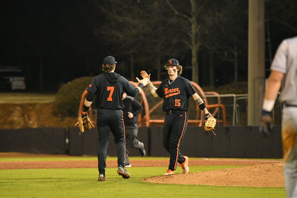 Brant Baughcum '26 and Logan Shepherd '27 high five during a game against the University of Pennsylvania on Feb. 27.