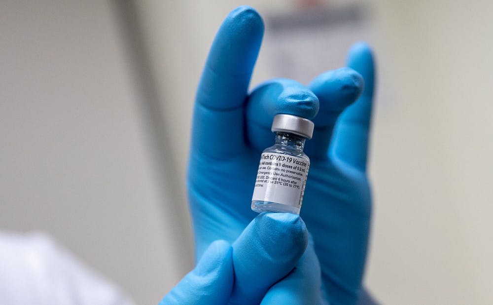 Army Spc. Angel Laureano holds a vial of the COVID-19 vaccine, Walter Reed National Military Medical Center, Bethesda, Md., Dec. 14, 2020. Free for use photo by Lisa Ferdinando.