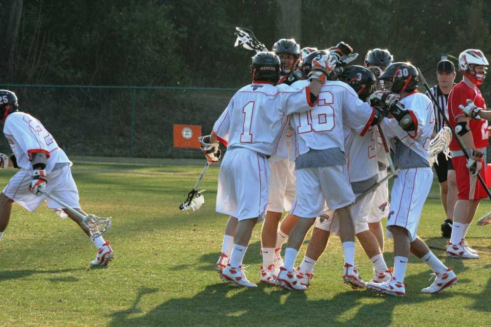(Alex Lockwood / Cluster Staff) The lacrosse team had plenty of reason to celebrate during the team's first victory in program history, 17-13, over Carthage College.