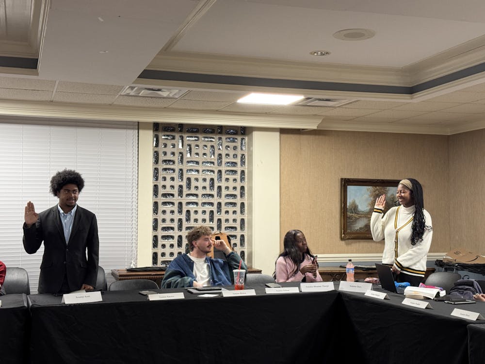 Senators  Micah Scott '27 (left) and Kendall Ross '25 (right) are sworn in at the Mercer Student Government Association's weekly meeting on Jan. 27, 2025. 