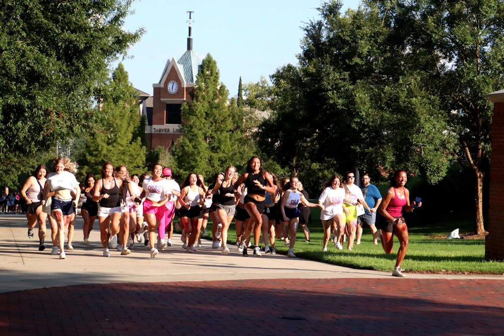 Girls who have received and accepted bids for sororities run the hill for 2023 Fall Recruitment on “Bid Day."