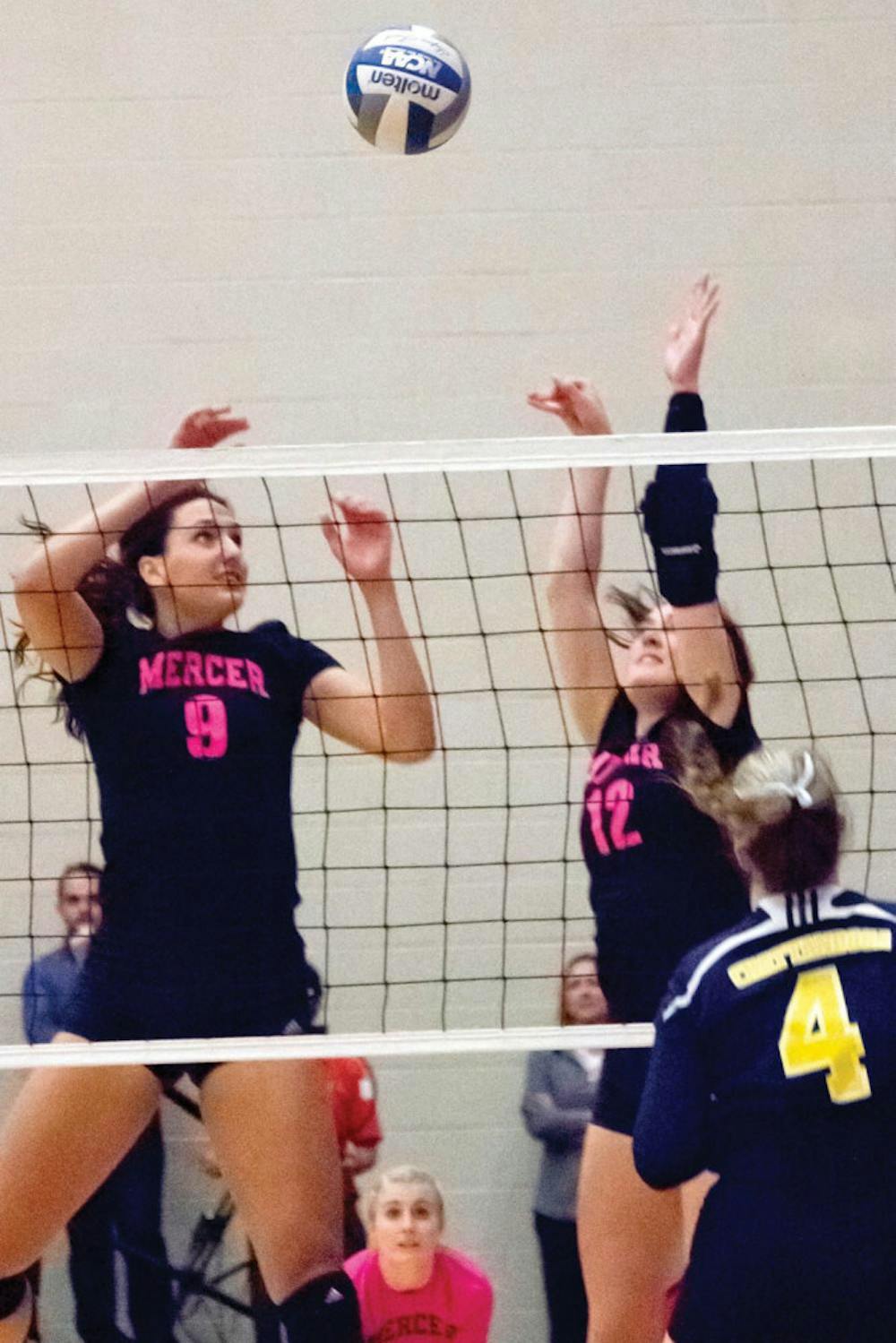 Middle blocker Paige Alsten and outside hitter Morgan MacGilvary jump to block the ball in their Oct. 29 match against University of Tennessee Chattanooga. The bears wore pink in recognition of Breast Cancer Awareness Month.