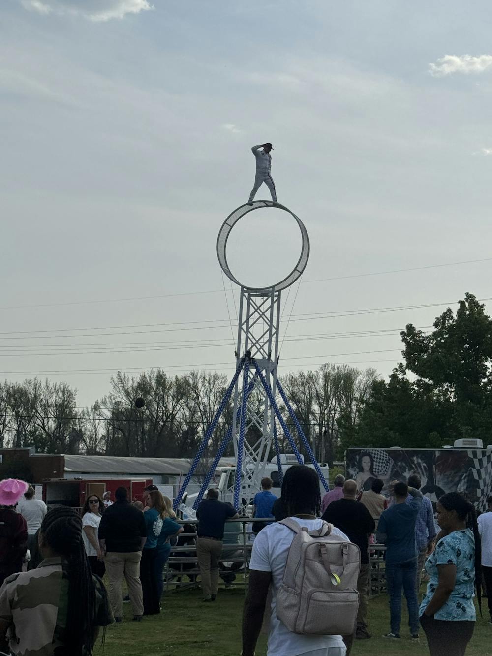 An acrobat balances on top of his spinning hoop act at the Cherry Blossom Fair in Macon.