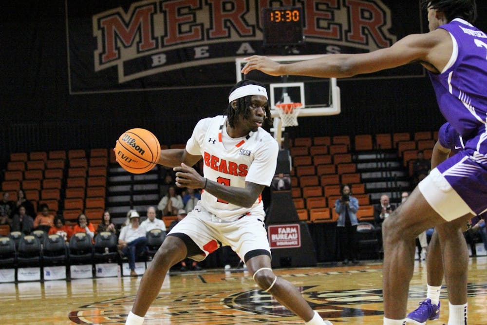 Baraka Okojie '27 jukes a defender in a game against Furman University on Feb. 11.