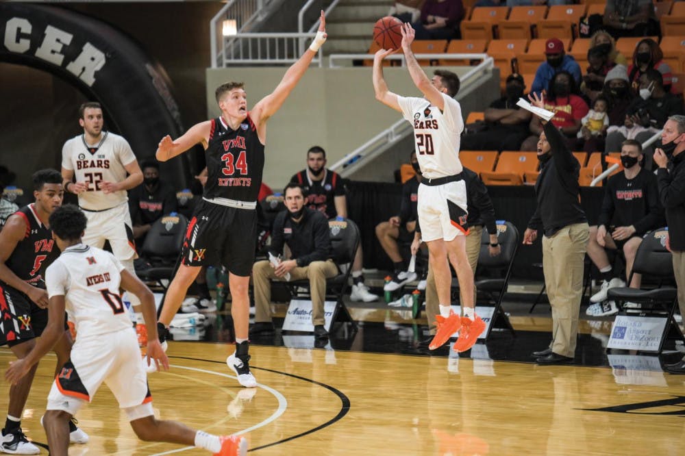 Mercer's Ross Cummings (#20) shoots over Samford's A.J. Stanton-McCray (#5). Cummings would make the shot to go toward his game high, 25 points, which propelled Mercer to an 89 to 82 victory over Samford in double overtime Feb. 8.