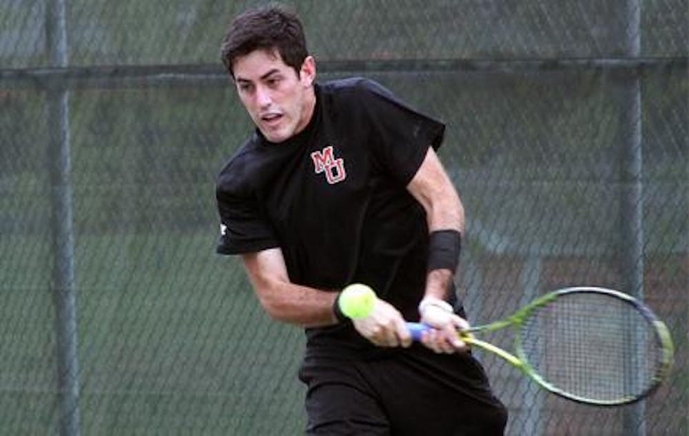 (photo courtesy of MercerBears.com) Fernando Armendaris looks to volley a serve during a recent match as the men's team fights to stay around the .500 mark for the season.