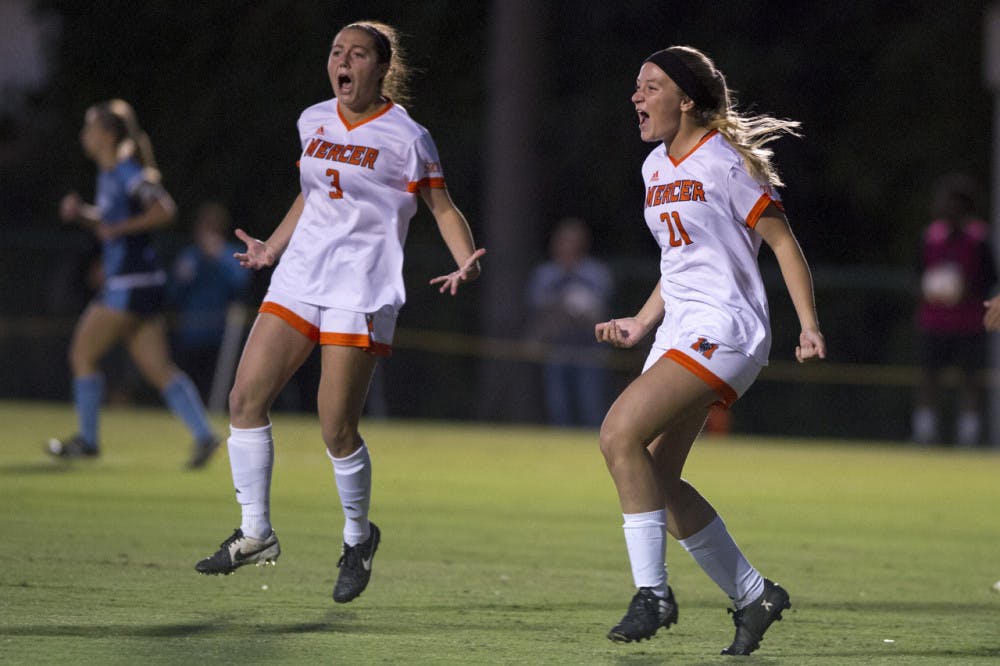 Mercer's Ally Fordham (21) and Emma Chandlee (3) celebrate after Fordham scored the first goal in the first 45 seconds of their soccer game against the Citadel at Mercer on Wednesday, October 25.