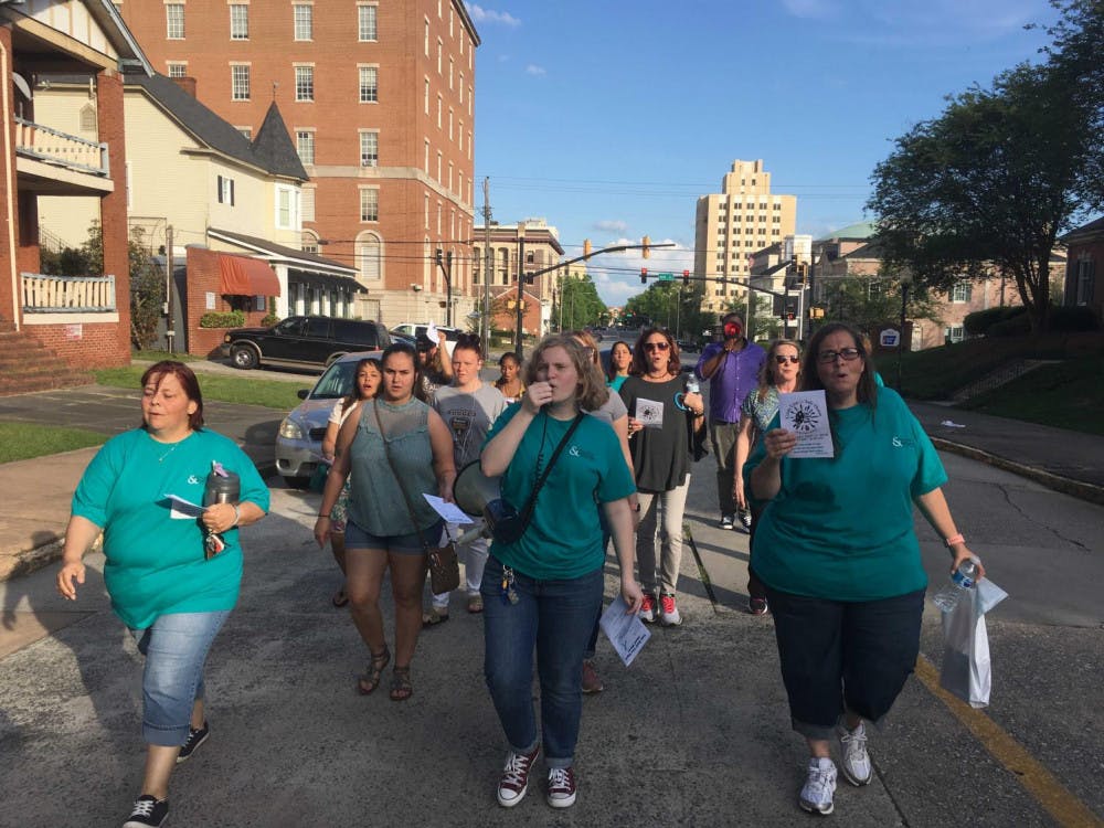 Mercer senior Emma Johnston helps lead a domestic violence prevention walk with Crisis Line and Safe House in April 2019. Archived photo provided by Emma Johnston