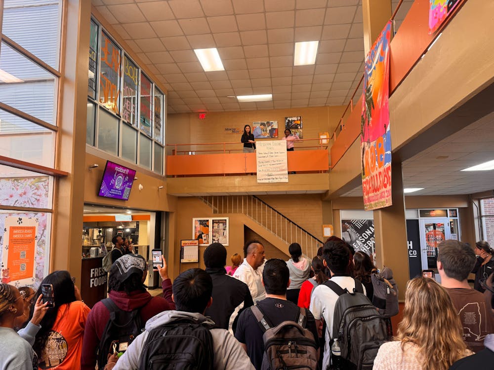 Students watch the banner drop on Thursday, March 12 as the Student Government Association announced this year's presidential election results.