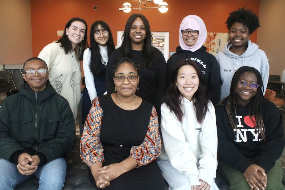 Students pose with Professor Obidoa during a "fireside chat" discussion event hosted by Mercer's global health department.