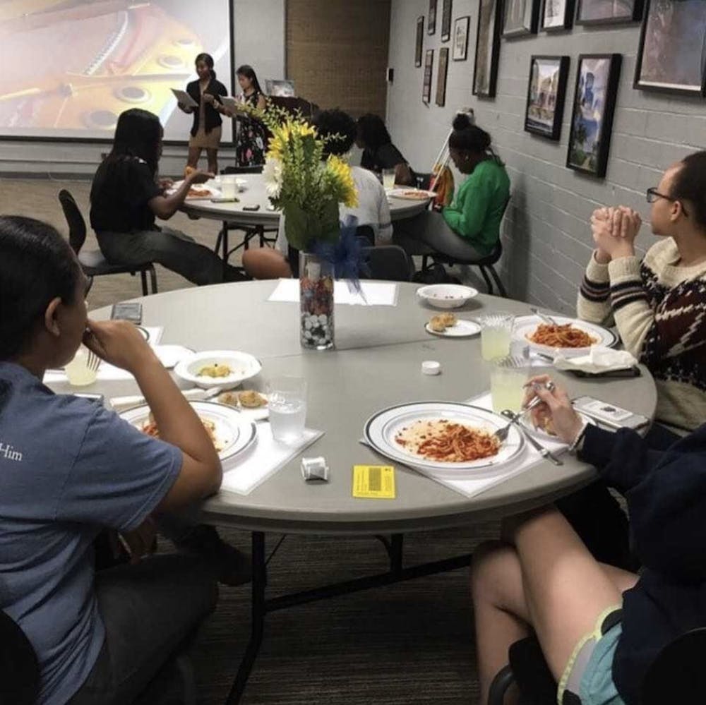 <p>Students participate in the Oxfam Hunger Banquet held in 2019. Image provided by McKenna Kaufman.</p>