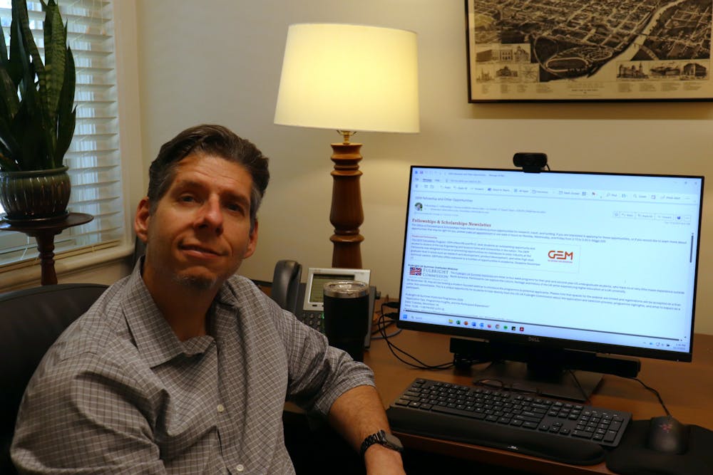 David Davis, who is director of fellowships and scholarships, smirked behind his computer screen, which displayed his Nov. 4 fellowships and scholarships newsletter.