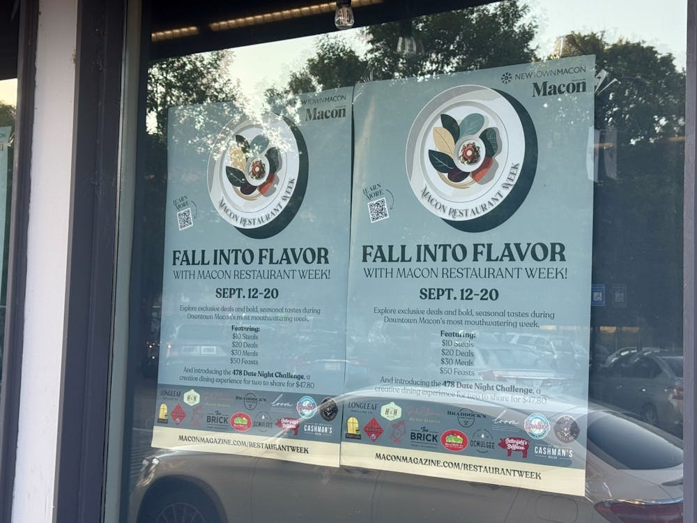An advertisement for the Macon Restaurant Week hangs in a downtown Macon window.