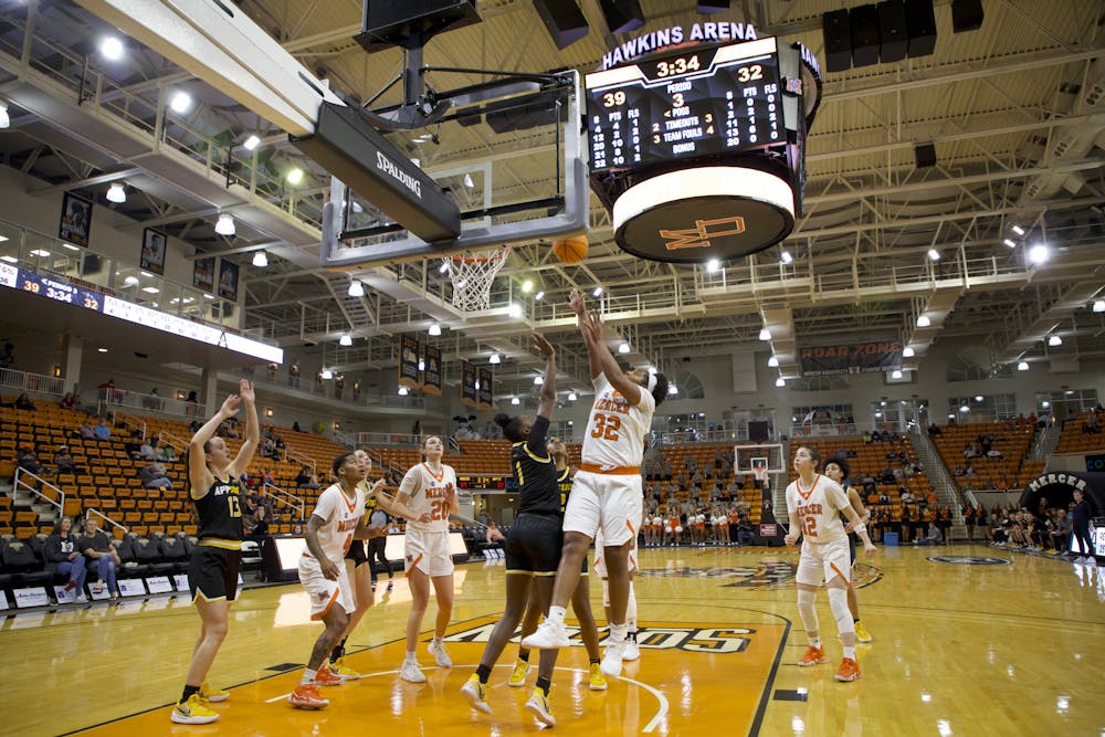 <p>Jaron Dougherty (#21) going up to shoot after gathering an offensive rebound in the Bears game against Appalachian State on Nov. 11. Dougherty ended the night with 15 points and 20 rebounds. </p>