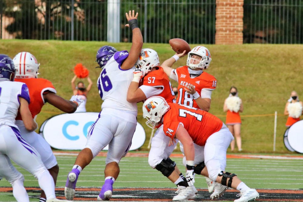 John Harris (57) blocks for Mercer’s quarterback Harrison Frost (18) as Frost attempts a pass during the second quarter of the game.