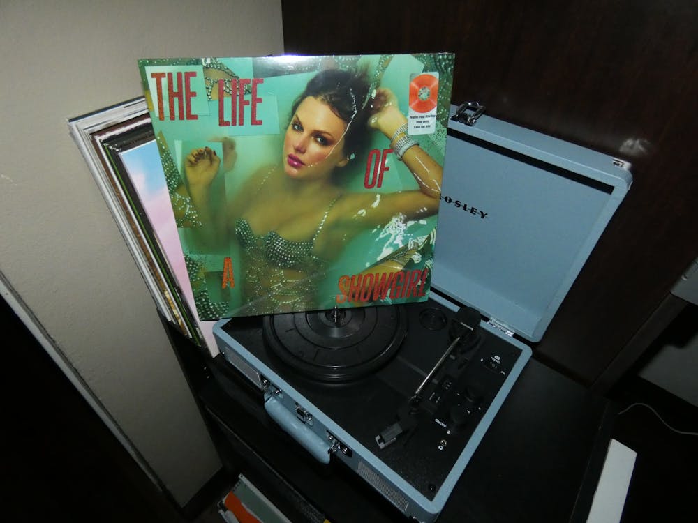 "The Life of a Showgirl" vinyl sits atop a record player.