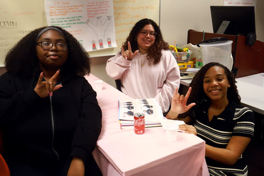 BearSigns’ Deaf Advocacy Coordinator Keyana Hunt, Secretary Emily Moran and President Desiree Banks, from left to right, posed for a portrait and signed “I love you" at BASL & Brushstrokes on Feb. 25, 2025.