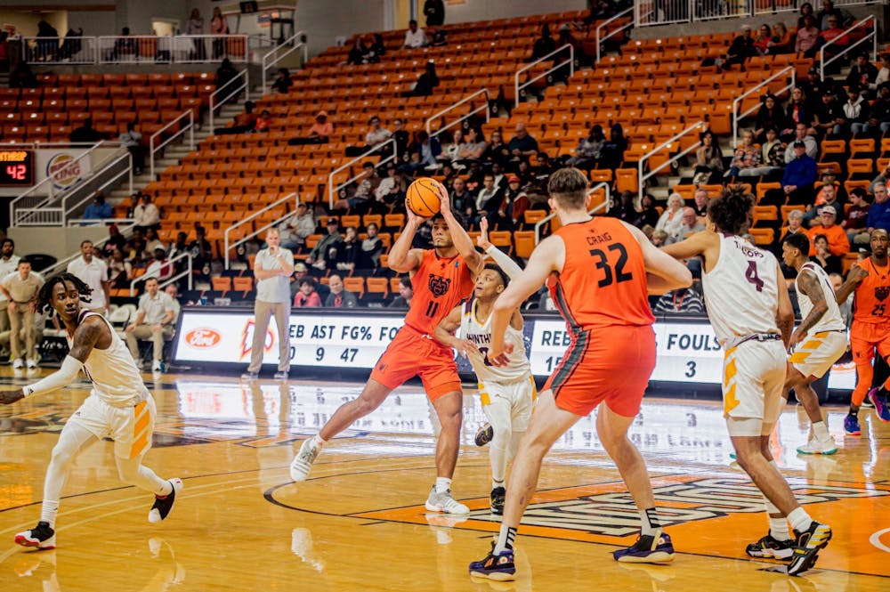 <p>Luis Hurtado Jr. (#11) looks for someone to pass to in the game against Winthrop University. Hurtado completed his first career double-double in the game with 10 assists and 10 points. Davis Craig (#23) also completed his first career double-double with 10 rebounds and 10 points. Photo provided by Mercer Athletics. </p>