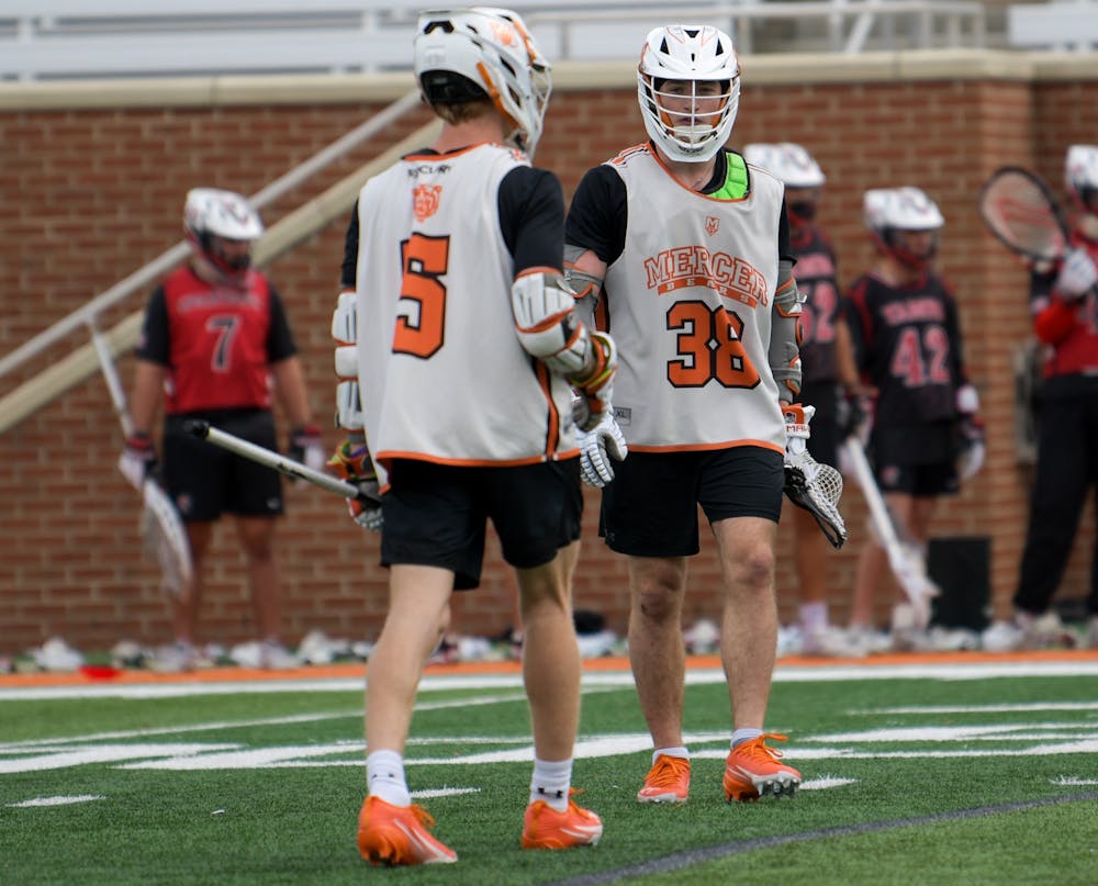 Will Zylstra ‘28 and Luke Fox ‘27 exchange glances in between plays during the men's lacrosse team’s preseason scrimmage.