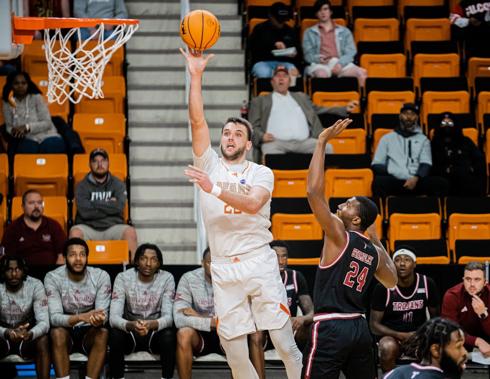 <p>Bears&#x27; forward Felipe Haase delivers a hook shot over Troy&#x27;s Nick Stampley Dec. 22. The Bears would lose the game 65-69. </p>