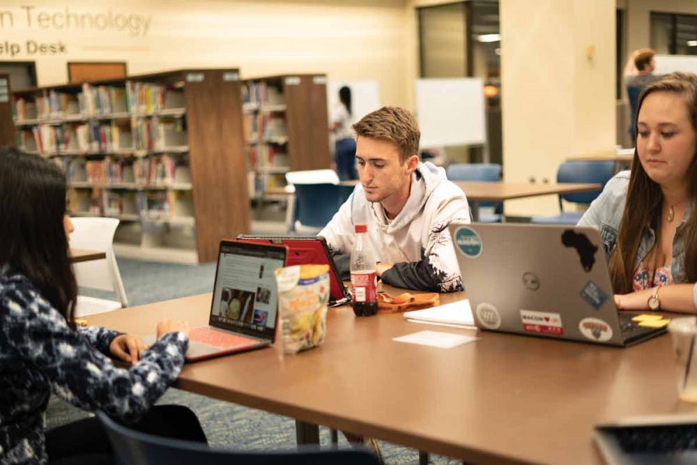 Daniel Wilson and Emily Cadle study in the library.