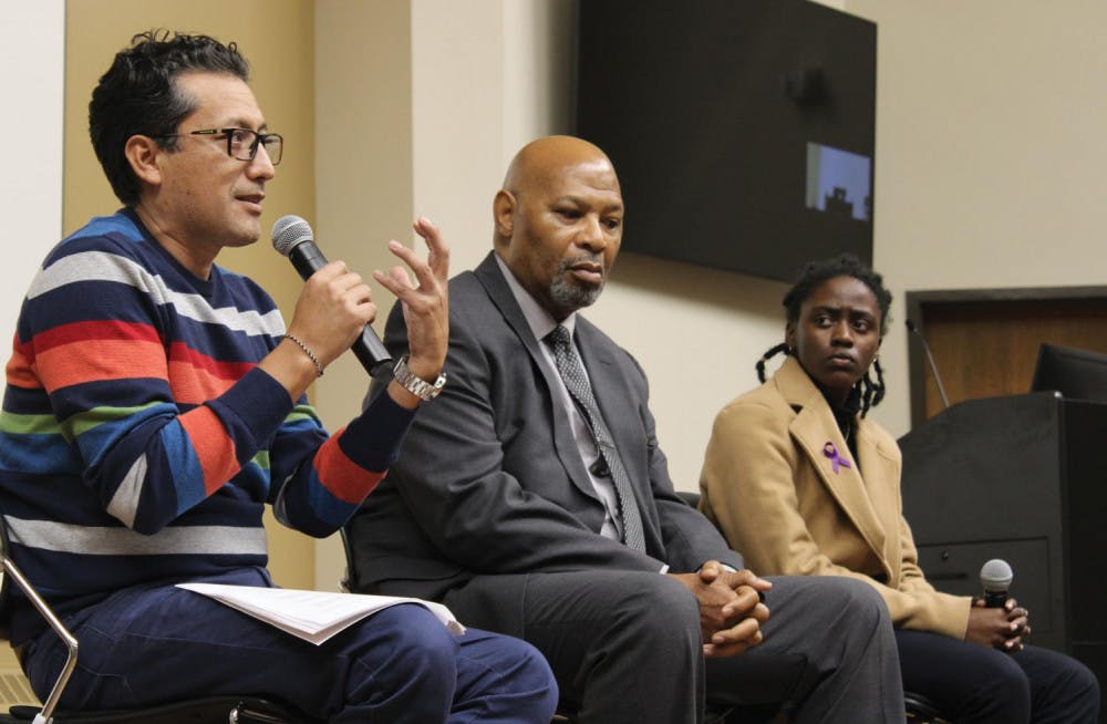 Professor Antonio Saravia (left) restates his argument as professor Chester Fontenot (middle) and student Genesis Cooper (right) listen.