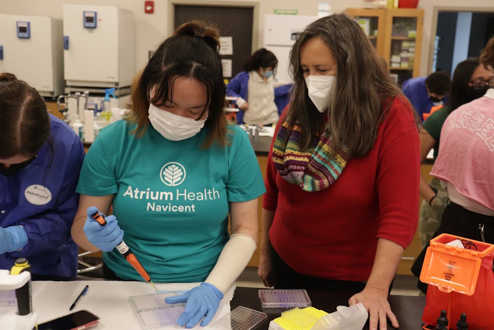 <p>Linda Hensel (right) watches Sophia Guo (left) micropipetting in the Genetics Lab.</p><p><br/></p>