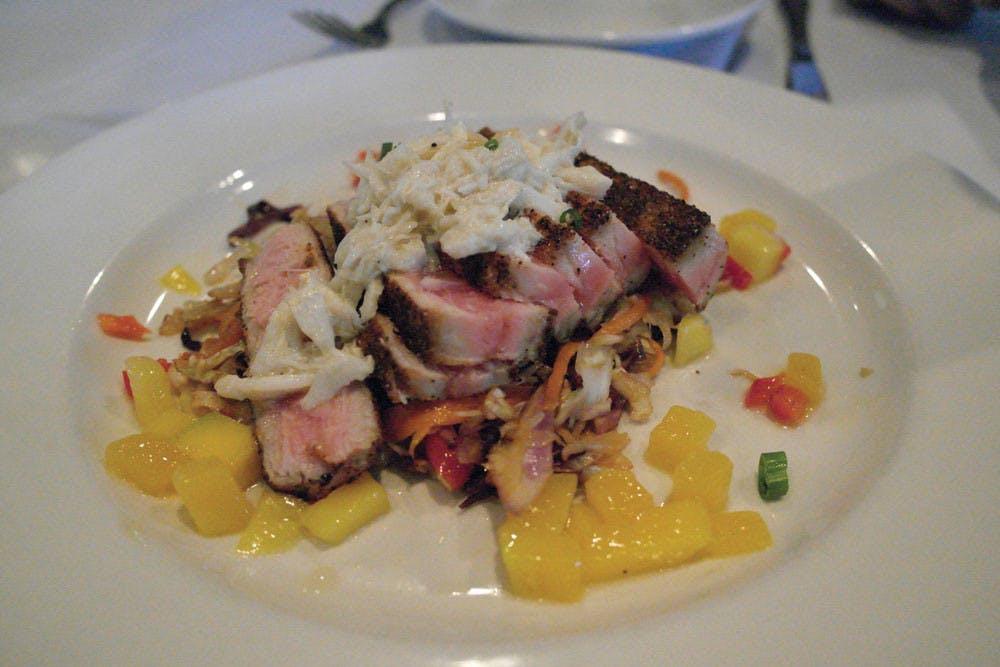 The tuna steak is served raw topped with crab meat and manages.