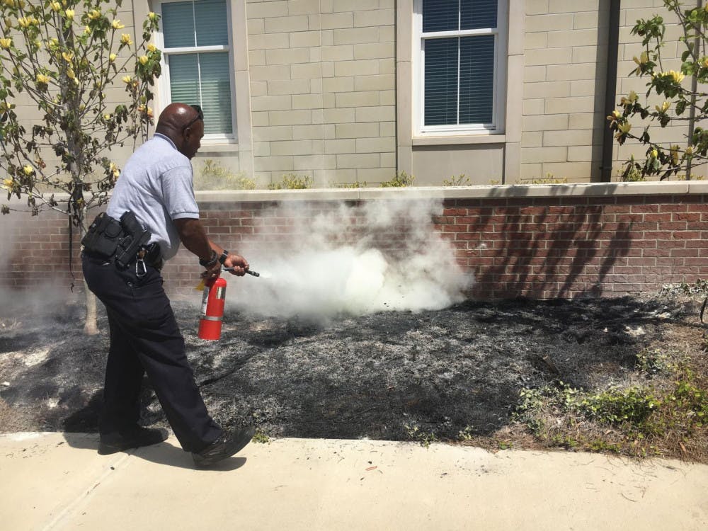 A MERPO officer extinguishes a fire outside Legacy.