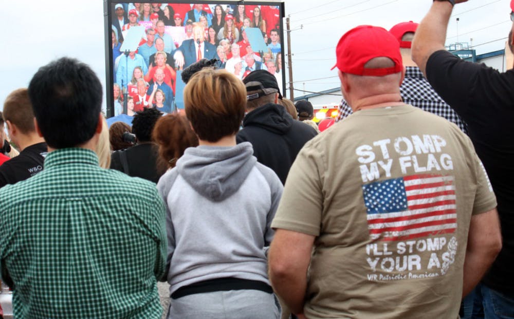 Trump supporters who arrived too late to see the president in person gather to watch on screen. Photo by Emily Rose Thorne.
