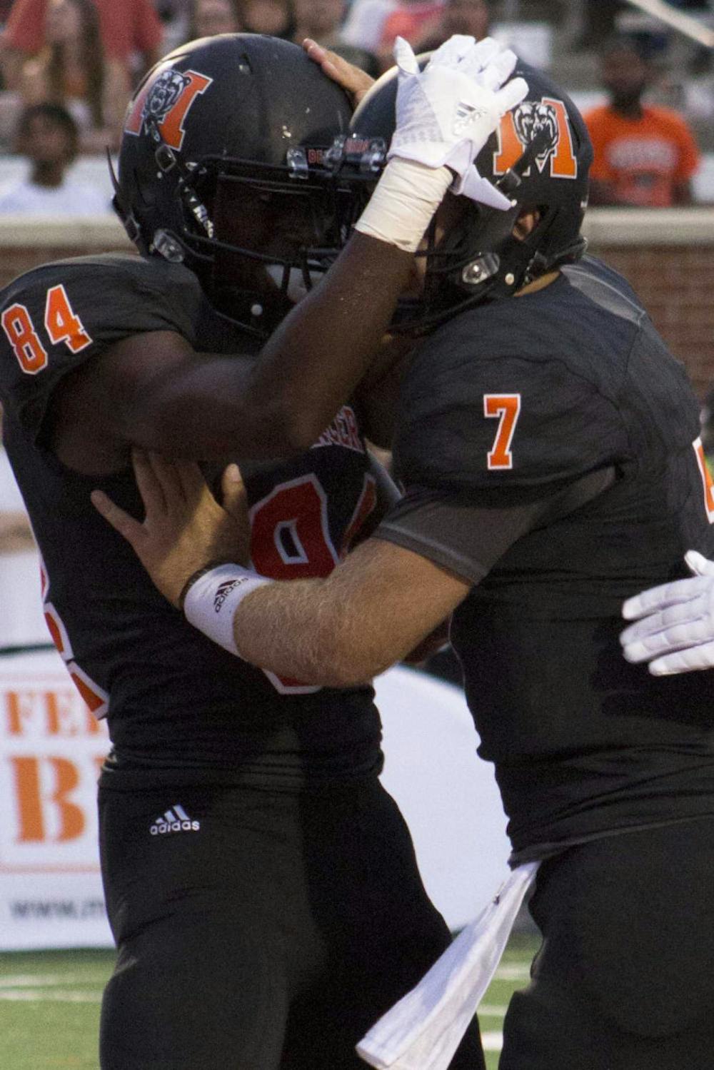 Mercer's Avery Ward (84), left, and John Russ (7) celebrate after the first touchdown in their game against The Citadel.