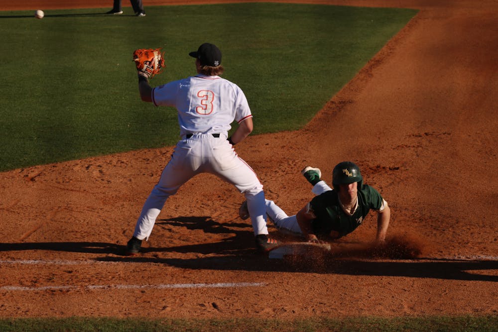 Ty Dalley tries to pick off a William and Mary player in February 2023.