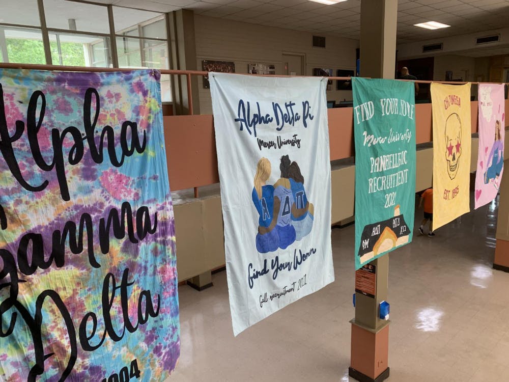 Banners advertising Panhellenic sororities and formal recruitment hang in the Connell Student Center.