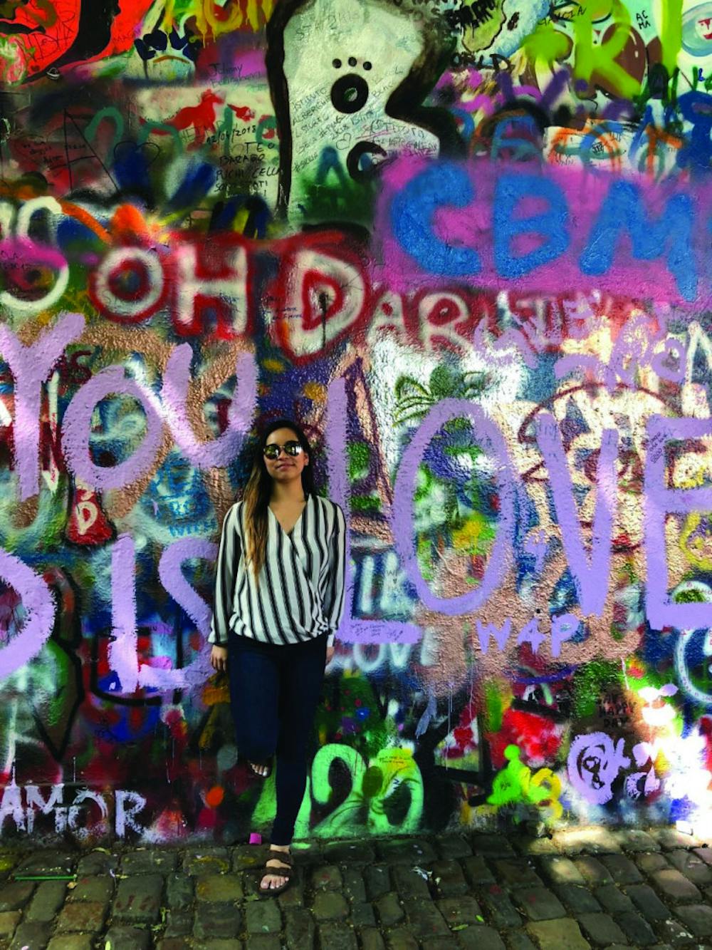 Sarah Grace Hall in front of a graffiti mural in the Czech Republic. Photo courtesy of Sarah Grace Hall