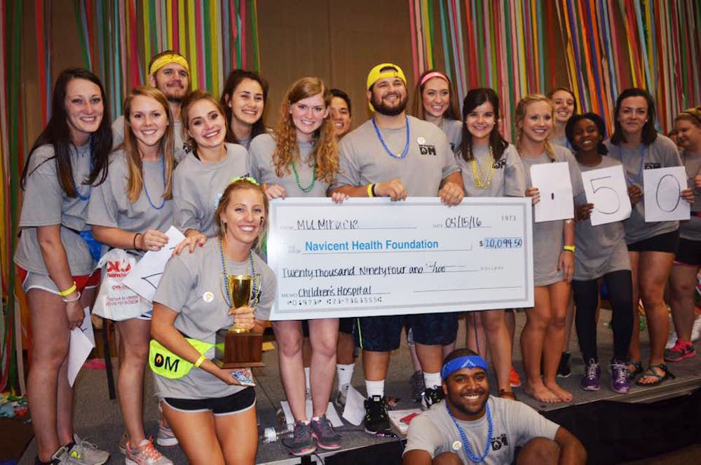 MU Miracle displaying check of fundraised money at last year's Dance Marathon in April.